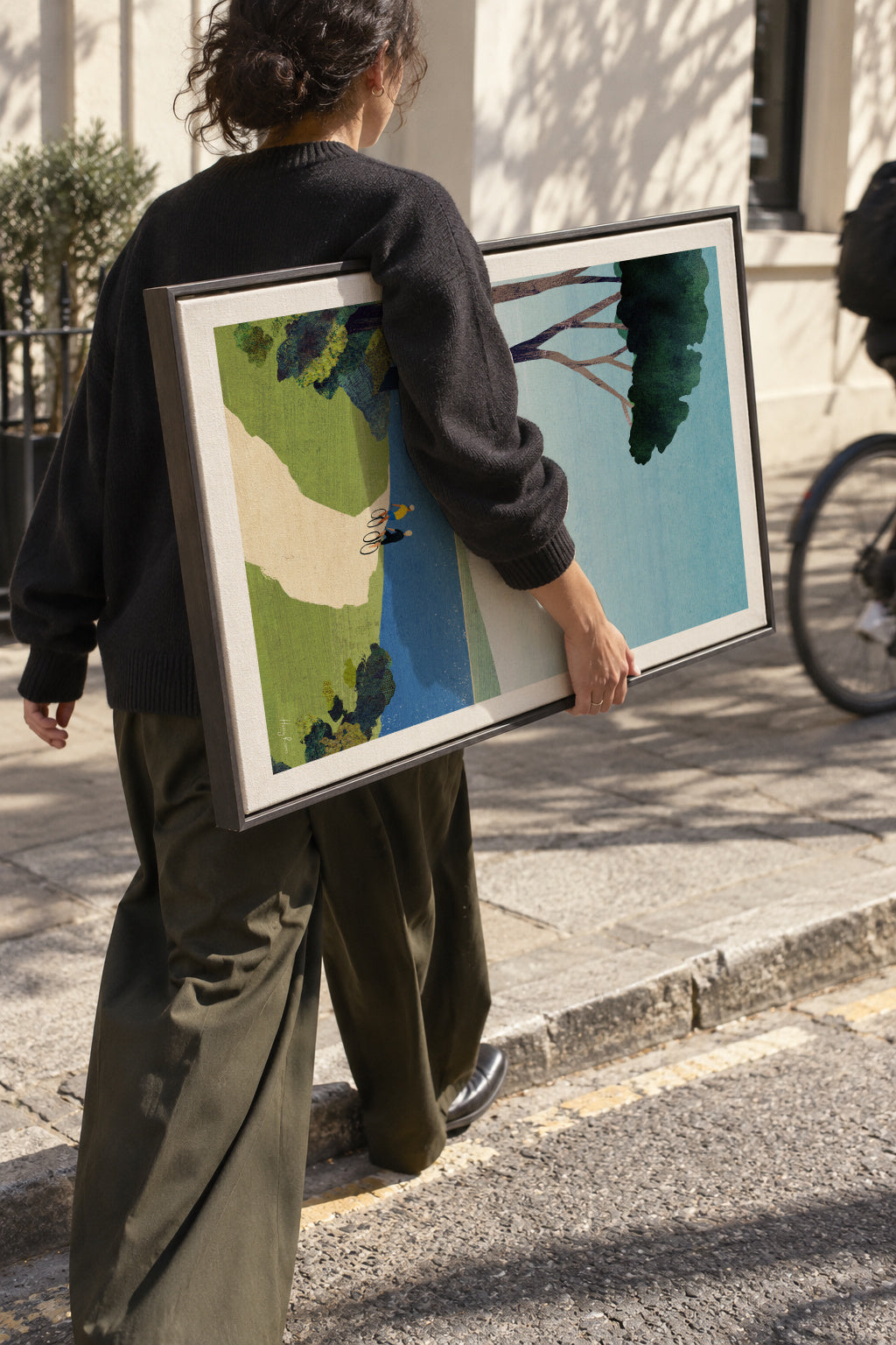 Cycling by the sea - Framed canvas in an interior
